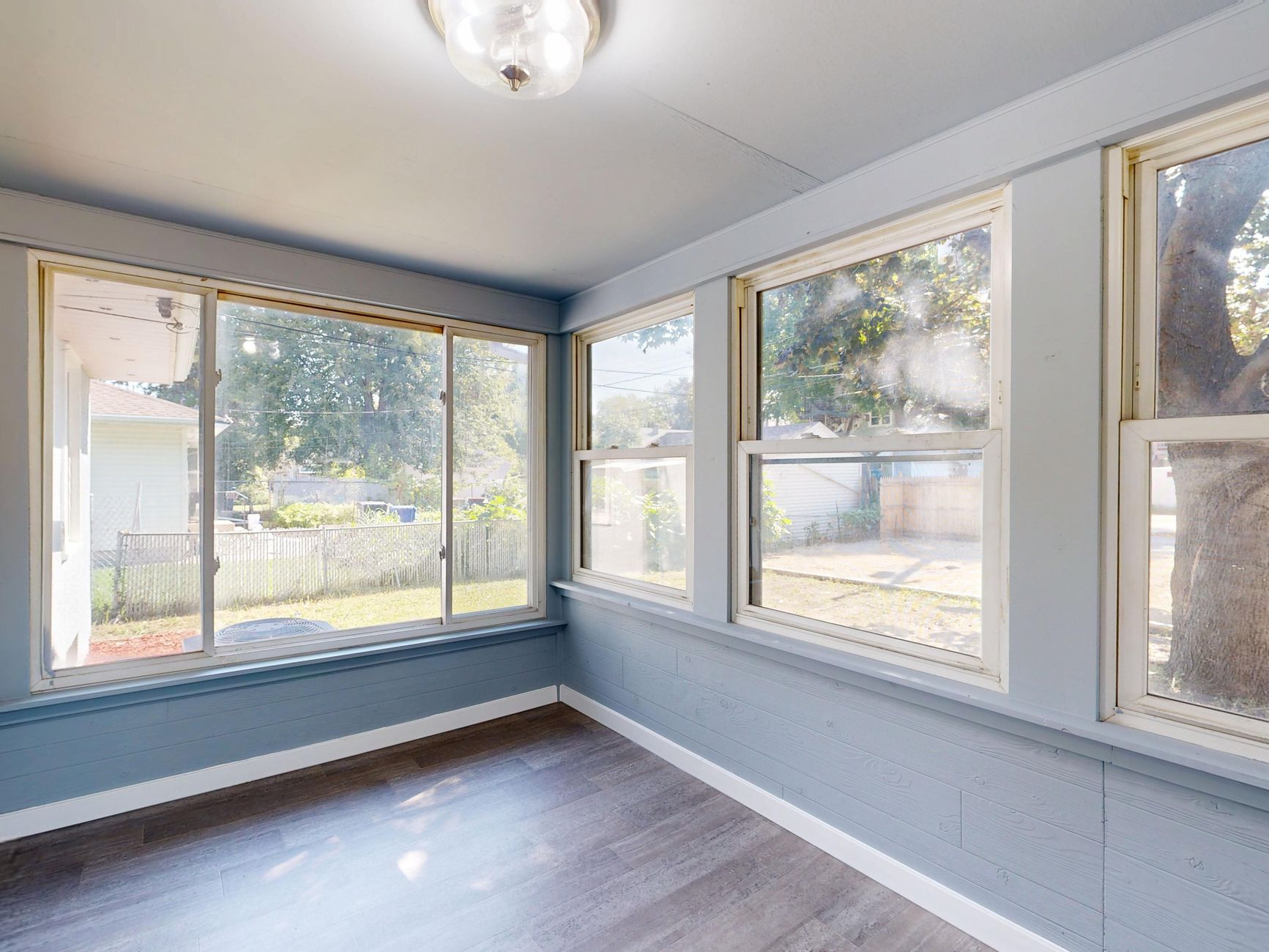 Spacious sunroom with large windows overlooking a garden. Perfect for relaxation in Austin, TX